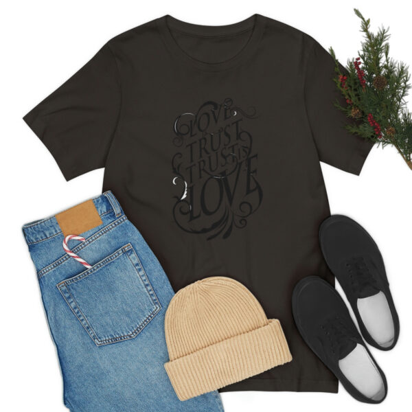 A black t-shirt and jeans with shoes, hat and christmas tree.