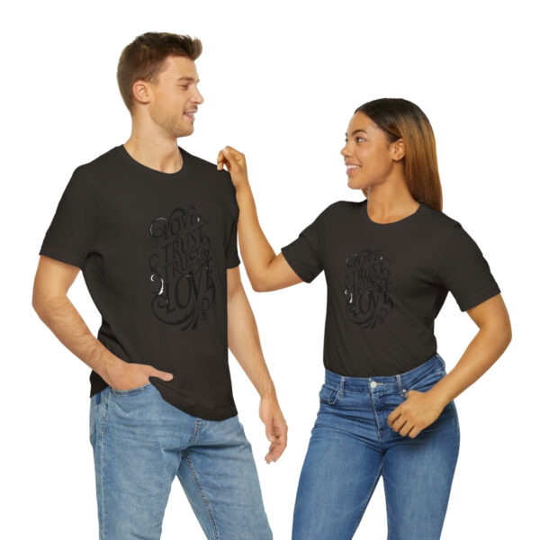 A man and woman holding hands while wearing black shirts.