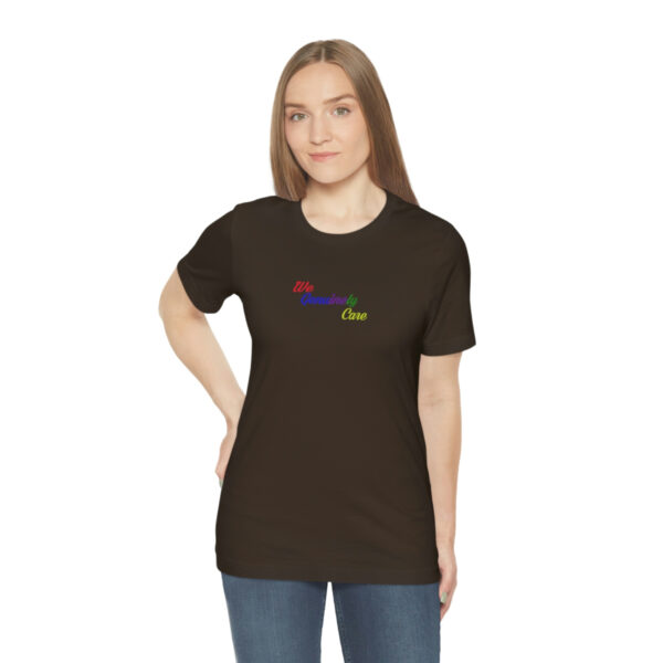 A woman wearing a black t-shirt with the word " rainbow ".