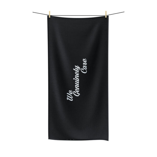 A black towel hanging on a clothes line.