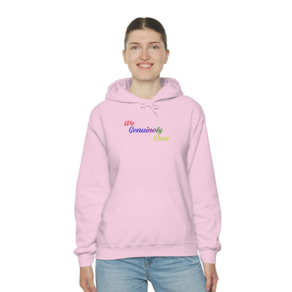 A woman wearing a pink hoodie with the words " my community is awesome ".