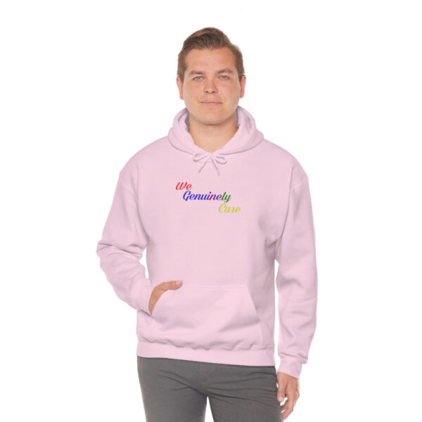 A man in a pink hoodie with the word " grandma " written on it.