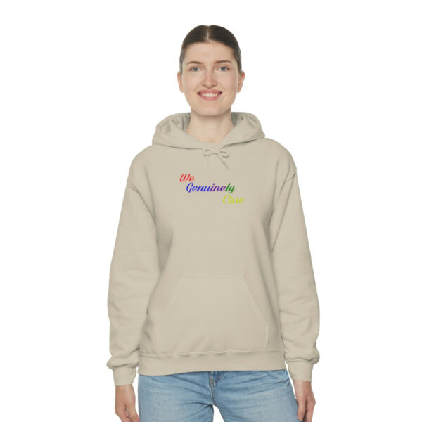 A woman wearing a beige hoodie with the words " i am somebody."