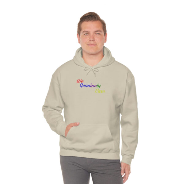 A man wearing a beige hoodie with the word " dreamers ".