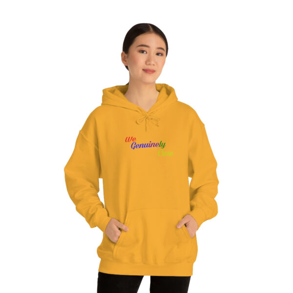 A woman in yellow hoodie with rainbow lettering.