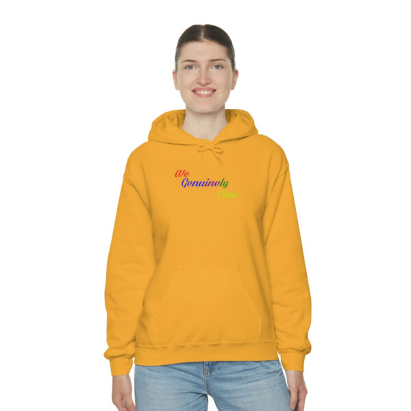 A woman wearing a yellow hoodie with the word " rainbow ".