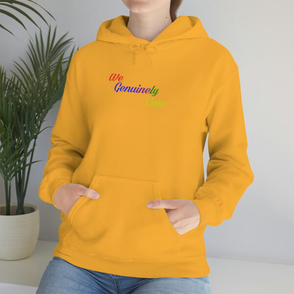 A person wearing a yellow hoodie with the word " somebody " embroidered on it.