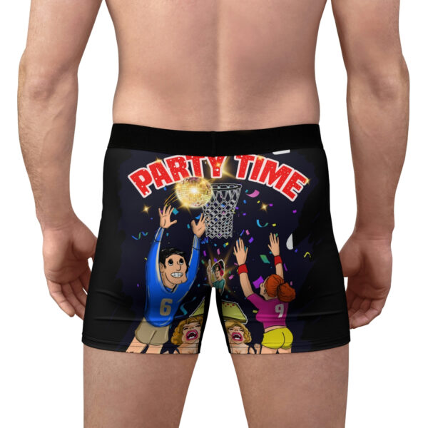 A man wearing black boxers with cartoon characters on them.