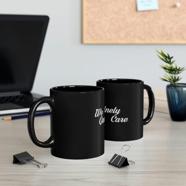 Two black mugs sitting on a table next to some papers