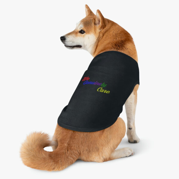 A dog wearing a shirt that says " rainbow breed ".