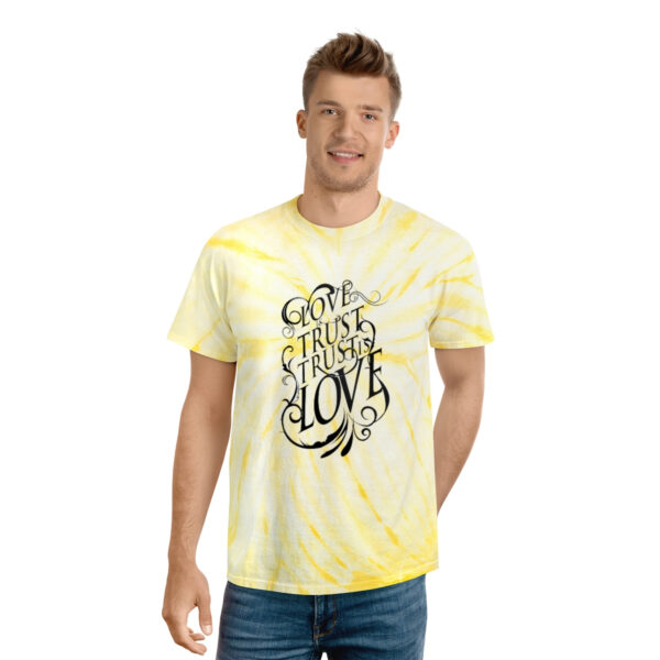 A man wearing a yellow tie dye t-shirt.