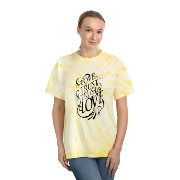 A woman wearing a yellow tie dye t-shirt.