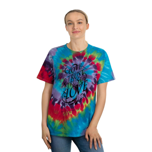 A woman wearing a tie dye t-shirt with the word love on it.