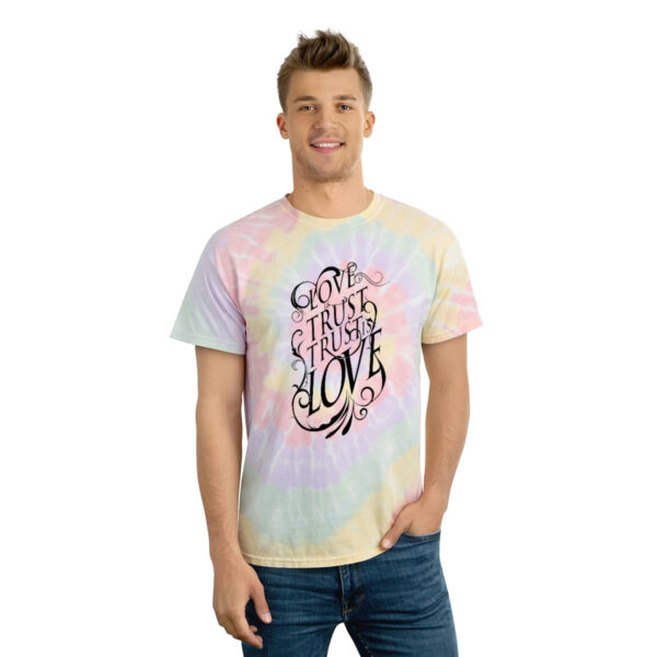 A man wearing a tie dye t-shirt with the words " i think you 're gay ".