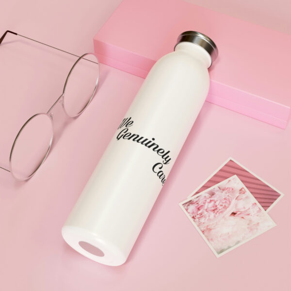 A white water bottle sitting on top of a pink table.