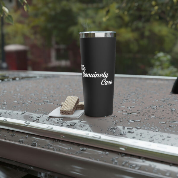 A cup of coffee on the side of a car.