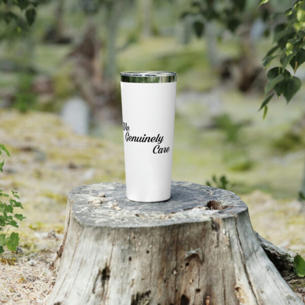 A white cup sitting on top of a tree stump.