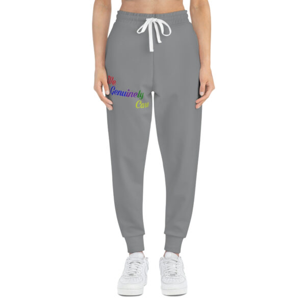 A woman is wearing grey sweatpants with white laces.