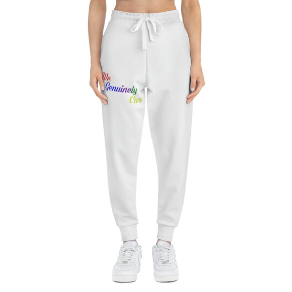 A woman is wearing white sweatpants with a rainbow design on the front.