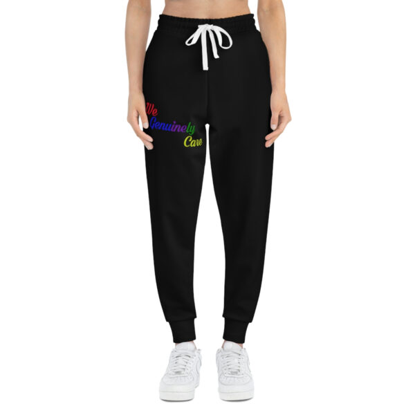 A woman wearing black sweatpants with the words " rainbow " on it.