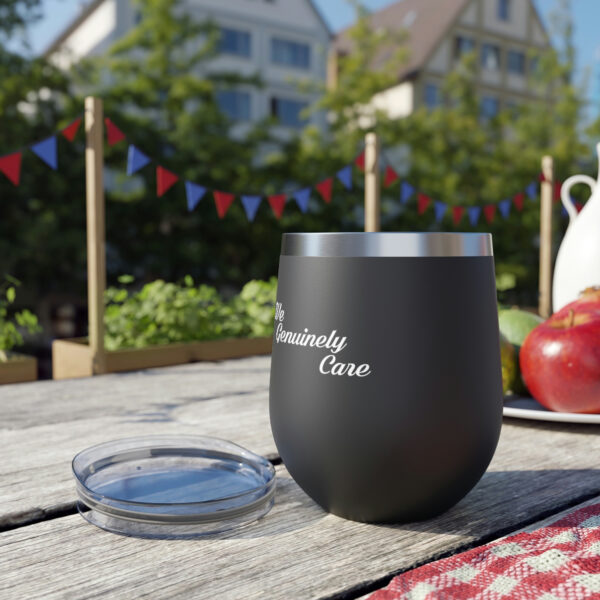 A cup sitting on top of a wooden table.