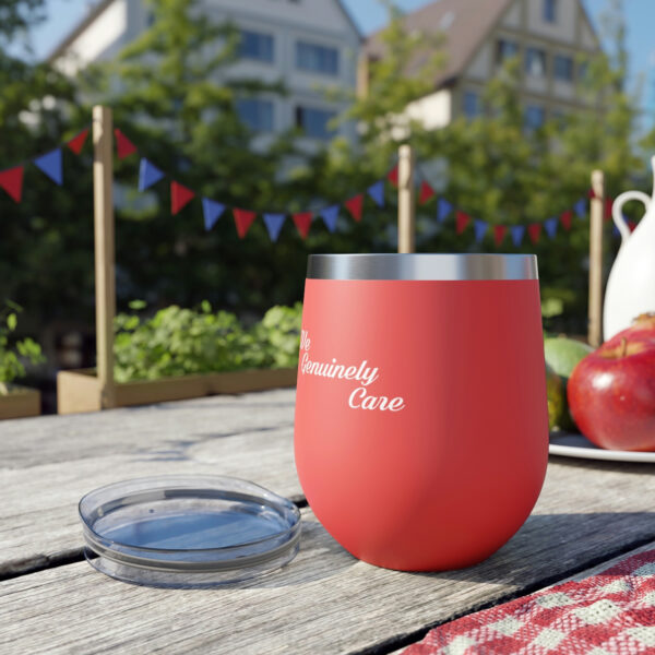 A red cup sitting on top of a wooden table.