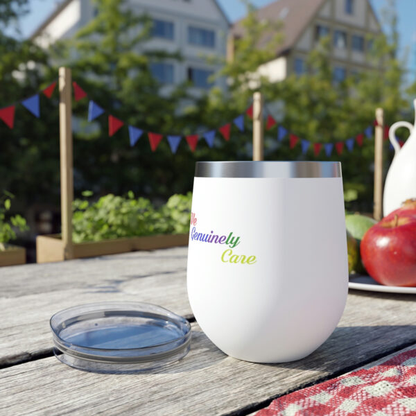 A cup sitting on top of a wooden table.