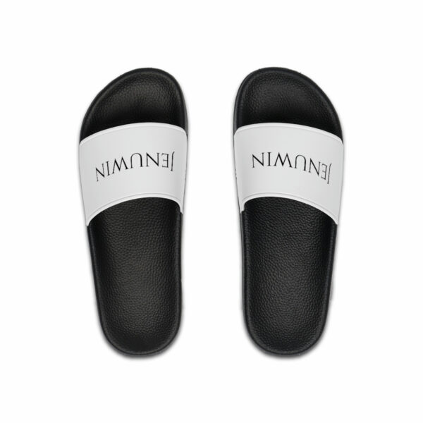 A pair of black and white sandals with the word " nimani " written on them.