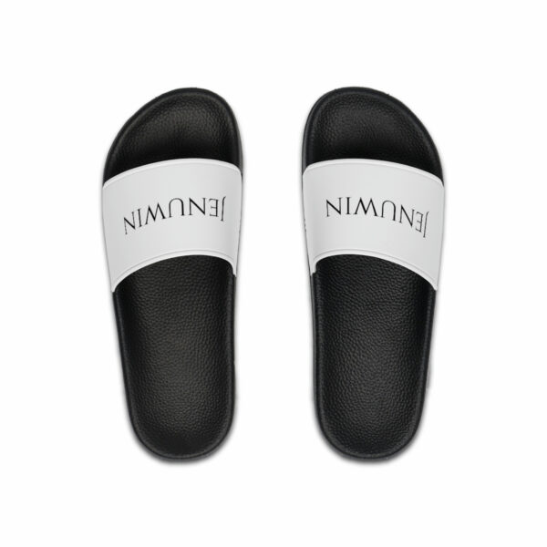 A pair of black and white sandals with the word " nimmu " written on them.