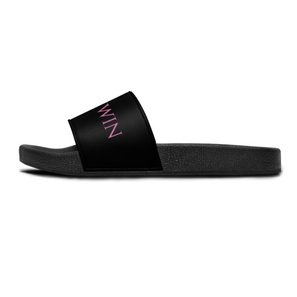 A pair of black slides with pink lettering on them.
