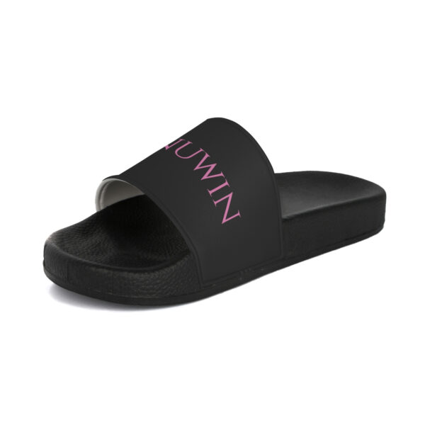 A pair of black slides with pink lettering.