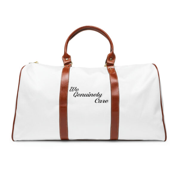 A white duffel bag with brown leather handles.