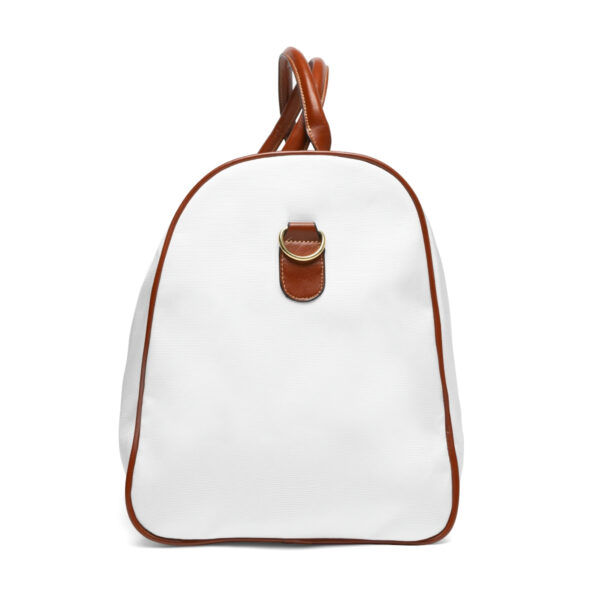 A white duffel bag with brown leather handles.