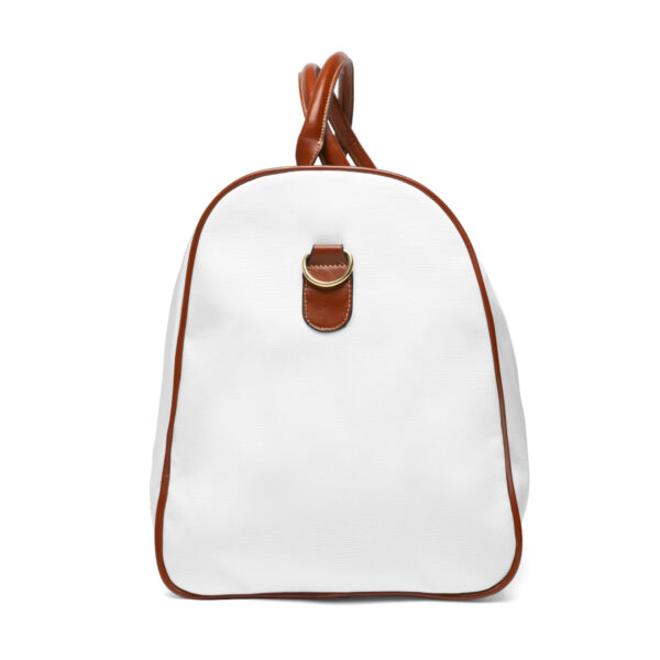 A white duffel bag with brown leather trim.