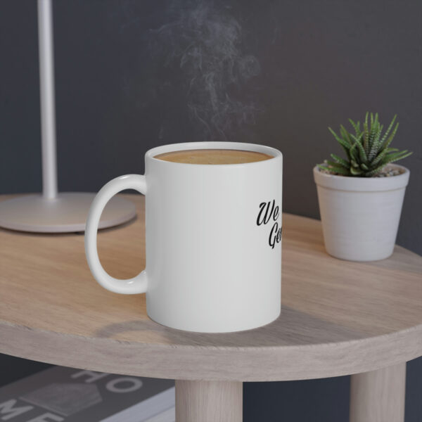 A coffee mug sitting on top of a wooden table.