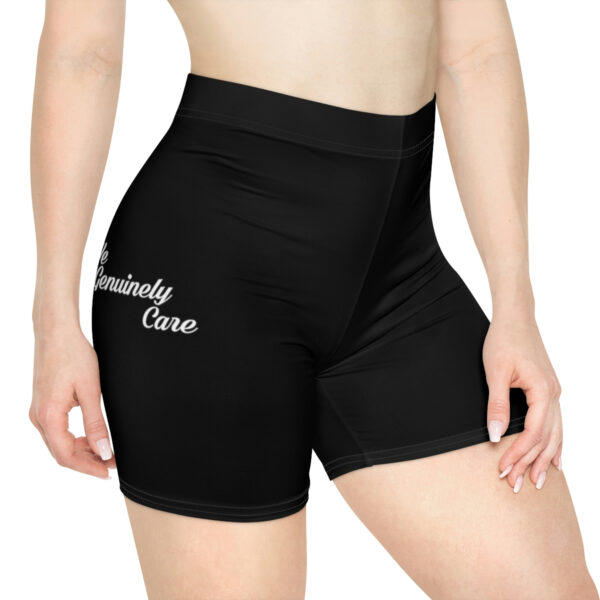 A woman wearing black shorts with white writing on it.