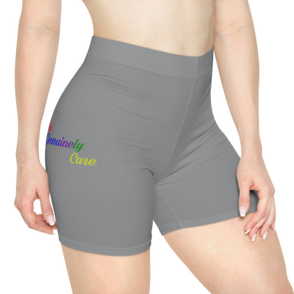 A woman wearing grey shorts with rainbow lettering.