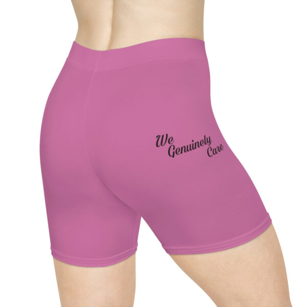 A woman wearing purple shorts with the words " ms. Grammie 's care ".