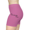 A woman wearing purple shorts with the words " community care ".